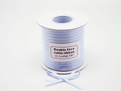 Snowflakes in medium blue on ice blue 5/8 single face satin ribbon